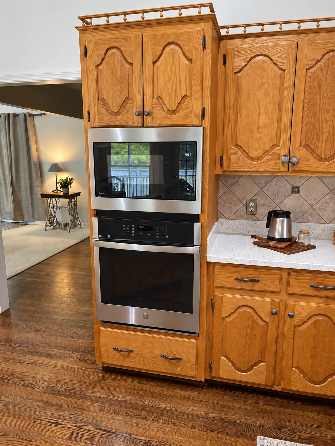 Built-in stainless steel microwave and wall oven fitted into oak cabinetry